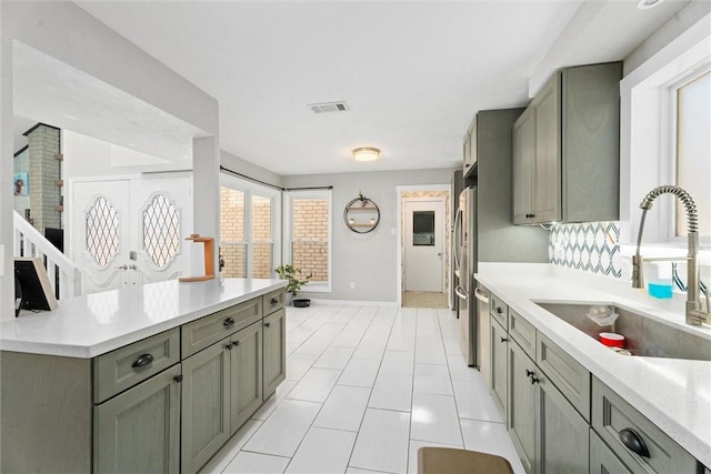 kitchen featuring stainless steel refrigerator and sink