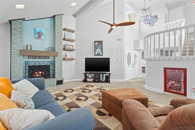 living room featuring high vaulted ceiling, a fireplace, light colored carpet, and beamed ceiling