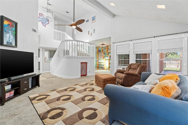 living room featuring ceiling fan with notable chandelier, light colored carpet, beam ceiling, and high vaulted ceiling