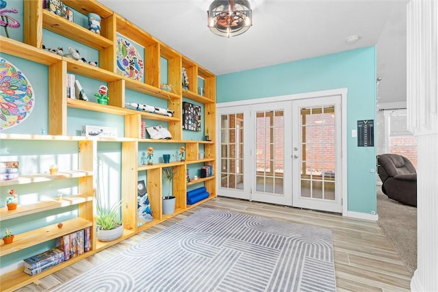 game room with french doors and light wood-type flooring