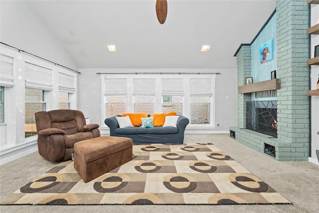 carpeted living room with lofted ceiling and a brick fireplace