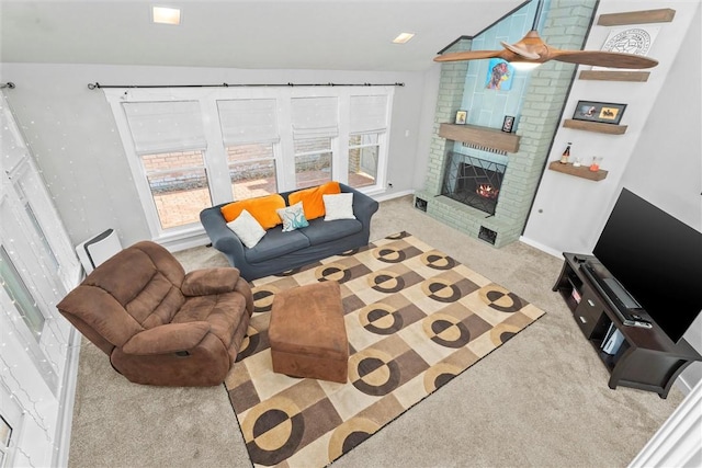 living room featuring a brick fireplace, vaulted ceiling, and light carpet