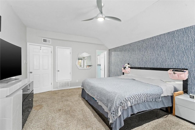 bedroom featuring vaulted ceiling, carpet flooring, and ceiling fan