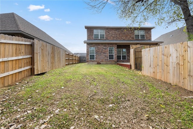 rear view of property with a lawn