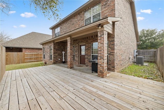 wooden deck featuring central AC unit