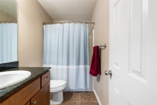 bathroom featuring vanity, curtained shower, and toilet