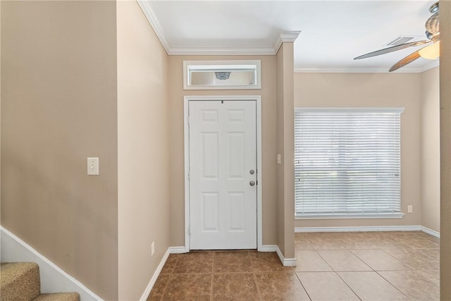 tiled foyer entrance featuring ceiling fan and crown molding