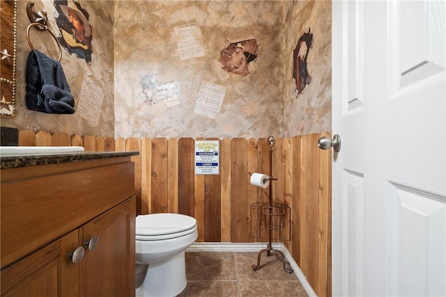 bathroom featuring tile patterned floors, vanity, and toilet