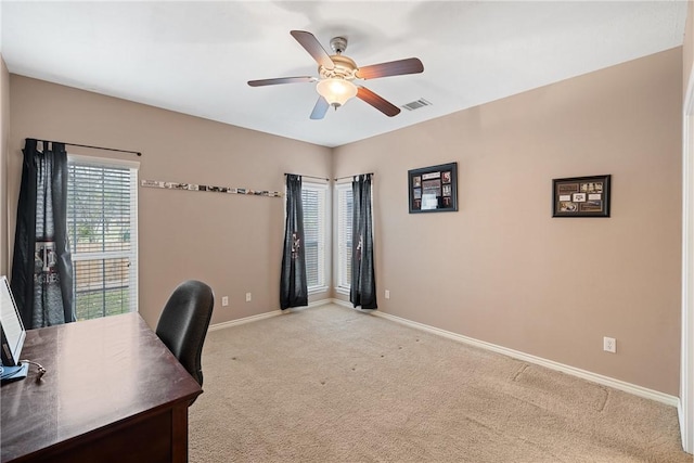 carpeted office featuring ceiling fan