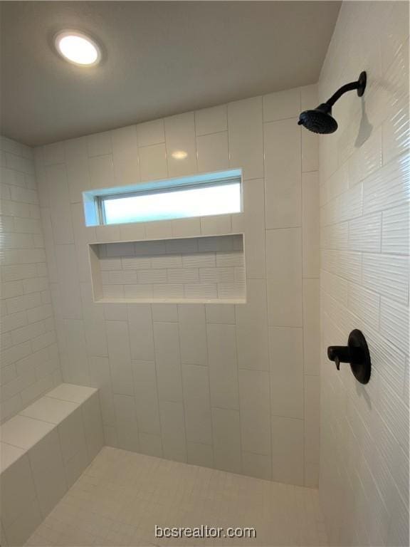 bathroom with tiled shower