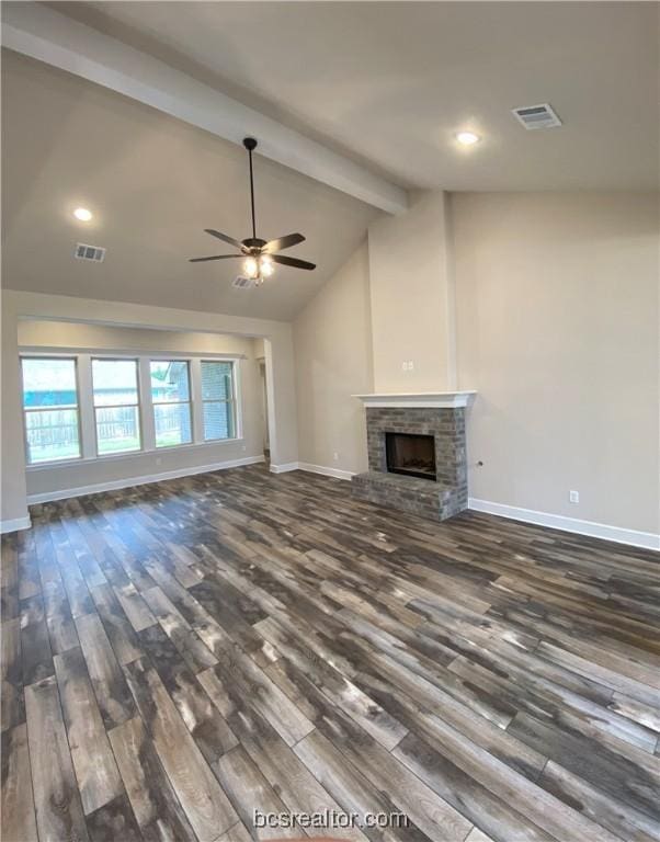 unfurnished living room featuring a fireplace, lofted ceiling with beams, ceiling fan, and dark wood-type flooring