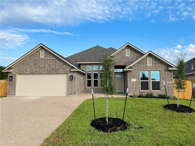 view of front facade with a front yard and a garage