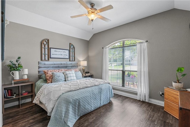 bedroom with a ceiling fan, vaulted ceiling, wood finished floors, and baseboards
