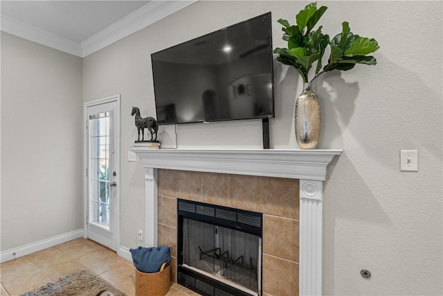 room details featuring crown molding, a tiled fireplace, and baseboards