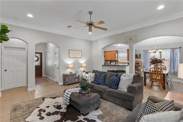 living room with visible vents, arched walkways, ceiling fan with notable chandelier, and light tile patterned flooring