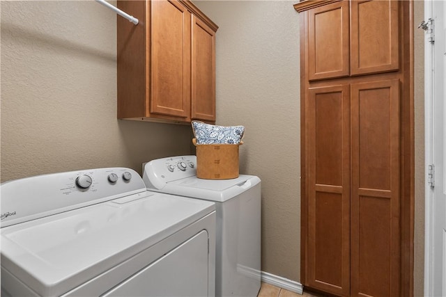washroom featuring cabinet space and washer and clothes dryer