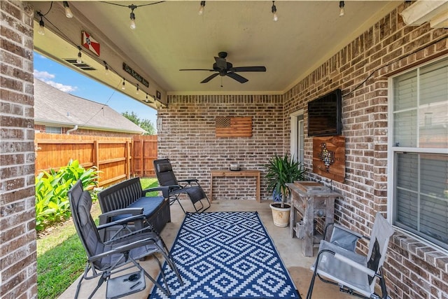 view of patio / terrace with fence, a ceiling fan, and outdoor lounge area