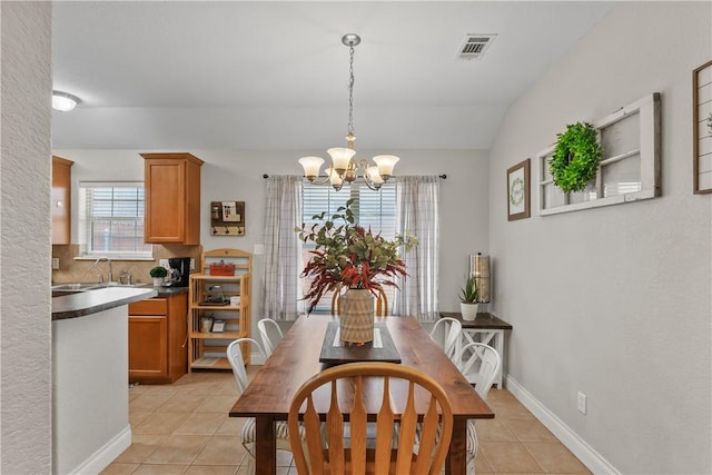 dining space with a wealth of natural light, visible vents, an inviting chandelier, and light tile patterned flooring