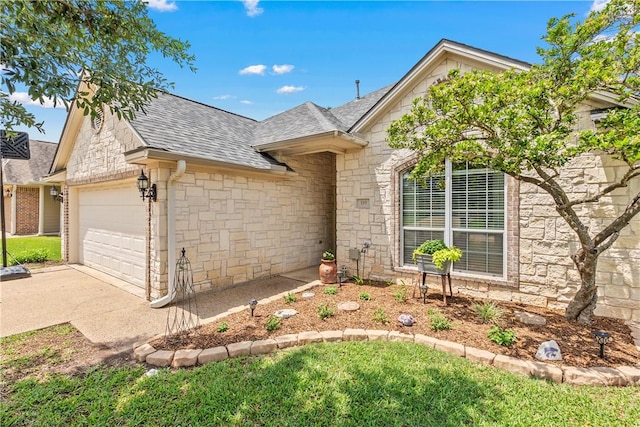 ranch-style home with driveway, stone siding, a shingled roof, and an attached garage