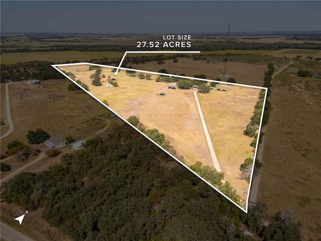 birds eye view of property with a rural view