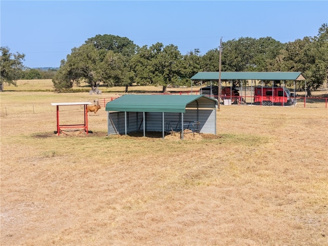 view of yard featuring a rural view and a carport