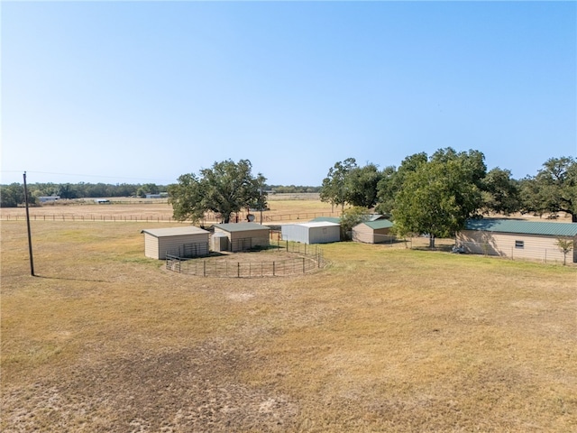 view of yard with a rural view and an outbuilding