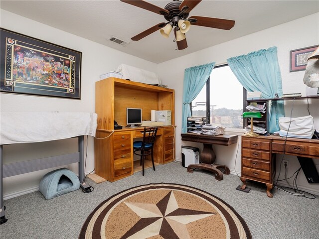 carpeted office space with ceiling fan