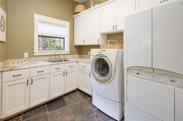 18140 Osage Trail Dr, College Station, TX 77845 - laundry area featuring cabinet space, independent washer and dryer, and dark stone finish floors