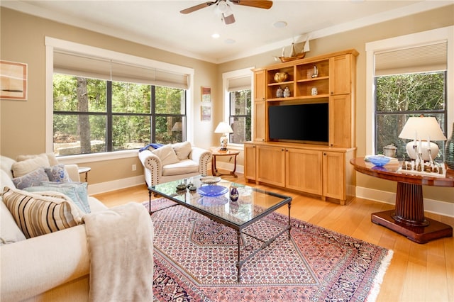 18140 Osage Trail Dr, College Station, TX 77845 - living area with plenty of natural light, a ceiling fan, light wood-style flooring, baseboards, and crown molding