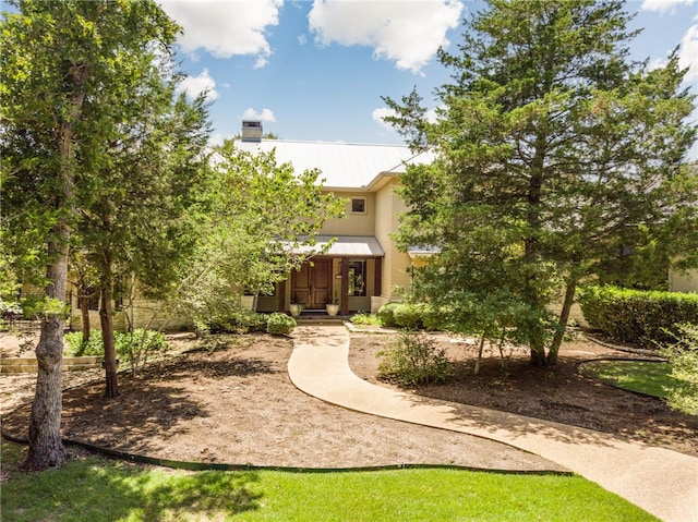 18140 Osage Trail Dr, College Station, TX 77845 - view of front of property with metal roof, stucco siding, and a chimney