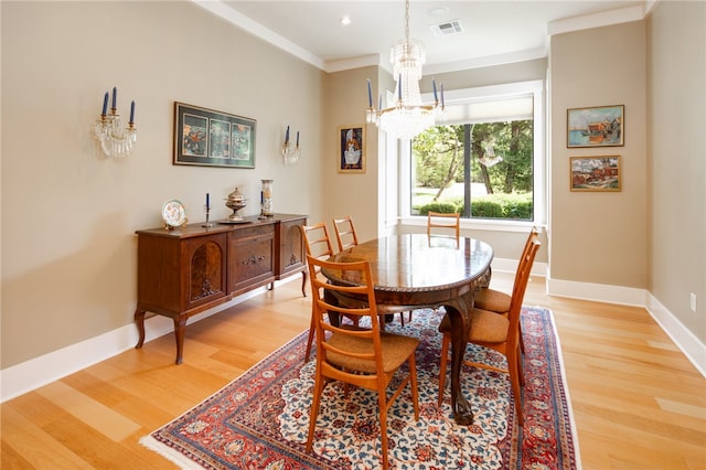 18140 Osage Trail Dr, College Station, TX 77845 - dining room with a chandelier, light wood-style flooring, crown molding, and baseboards