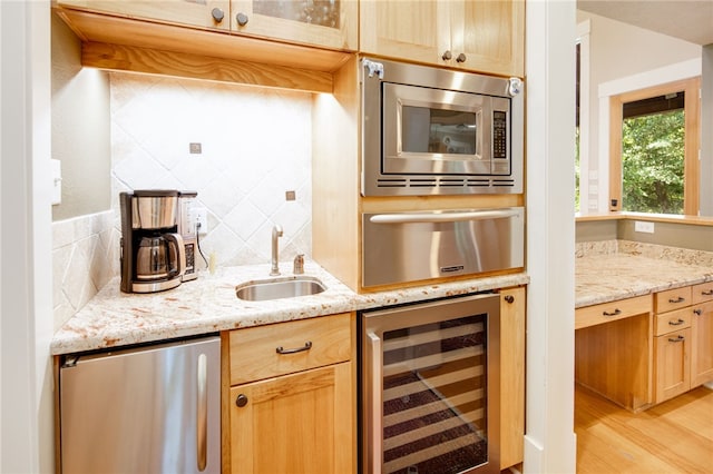 18140 Osage Trail Dr, College Station, TX 77845 - kitchen with wine cooler, stainless steel microwave, fridge, a sink, and a warming drawer