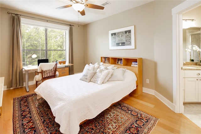 18140 Osage Trail Dr, College Station, TX 77845 - bedroom featuring light wood-style floors, ensuite bath, multiple windows, and a desk