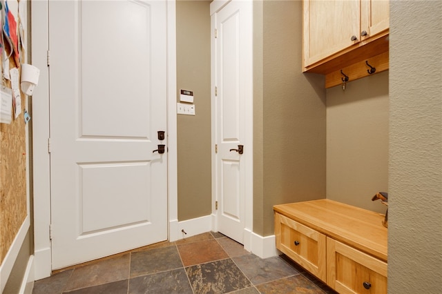 18140 Osage Trail Dr, College Station, TX 77845 - mudroom featuring stone finish flooring and baseboards