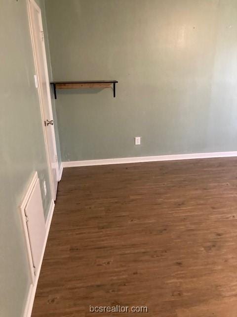 spare room featuring dark wood-type flooring