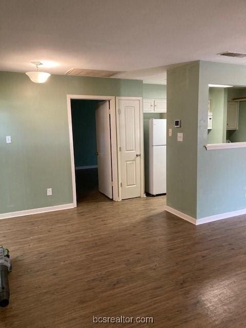 unfurnished room with hardwood / wood-style flooring