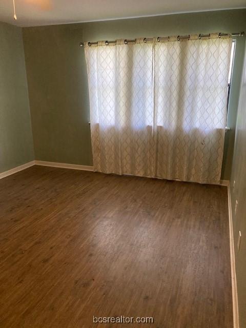 spare room with dark hardwood / wood-style floors