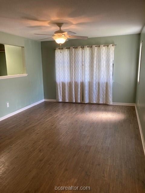 unfurnished room with ceiling fan and dark wood-type flooring