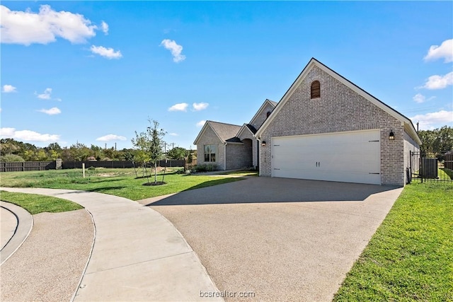 2160 Madden Cir, College Station, TX 77845 - view of front of home with brick siding, driveway, and an attached garage