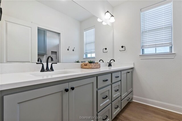 2160 Madden Cir, College Station, TX 77845 - bathroom featuring double vanity, wood finished floors, and baseboards