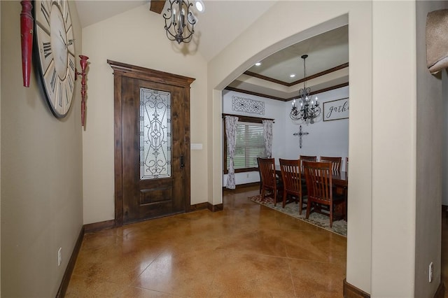 entrance foyer with arched walkways, baseboards, and a notable chandelier