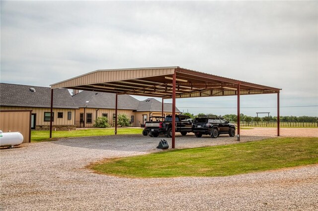 view of parking with a detached carport and gravel driveway