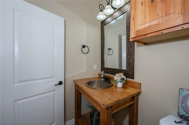half bath featuring vanity and toilet