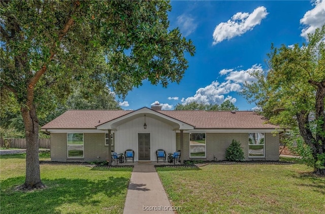 ranch-style home with a front lawn