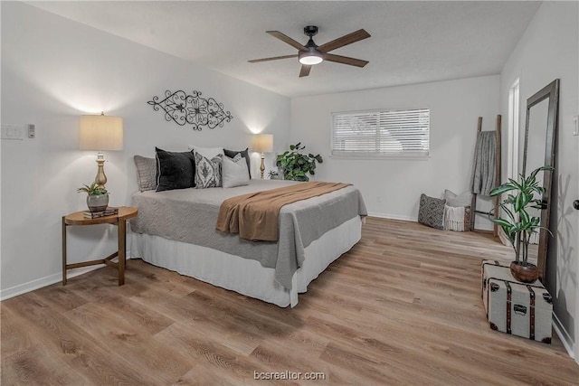 bedroom with ceiling fan and light wood-type flooring