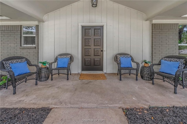 view of exterior entry featuring a patio