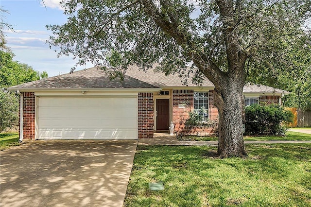 713 Broadmoor Dr, Bryan, TX 77802 - single story home with brick siding, concrete driveway, an attached garage, and a front lawn