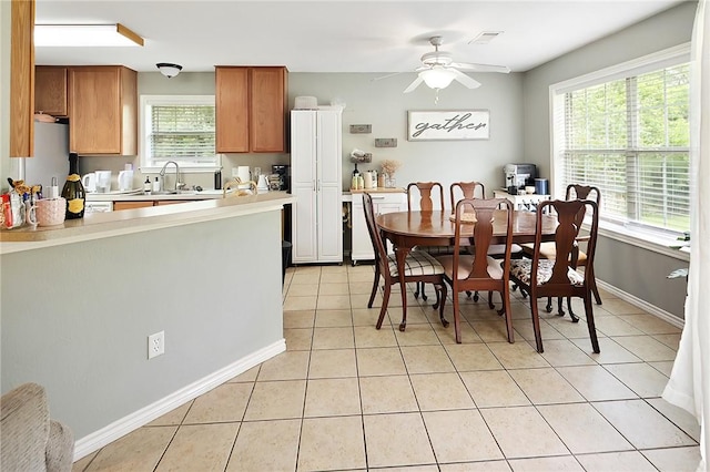 713 Broadmoor Dr, Bryan, TX 77802 - dining area with light tile patterned floors, ceiling fan, and baseboards