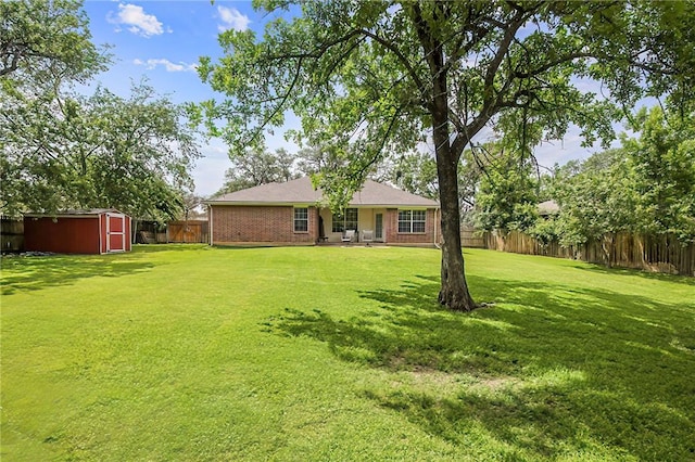 713 Broadmoor Dr, Bryan, TX 77802 - back of house featuring a storage unit, an outbuilding, and brick siding