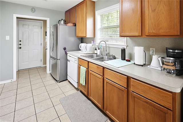 713 Broadmoor Dr, Bryan, TX 77802 - kitchen featuring dishwasher, a sink, light countertops, and light tile patterned floors